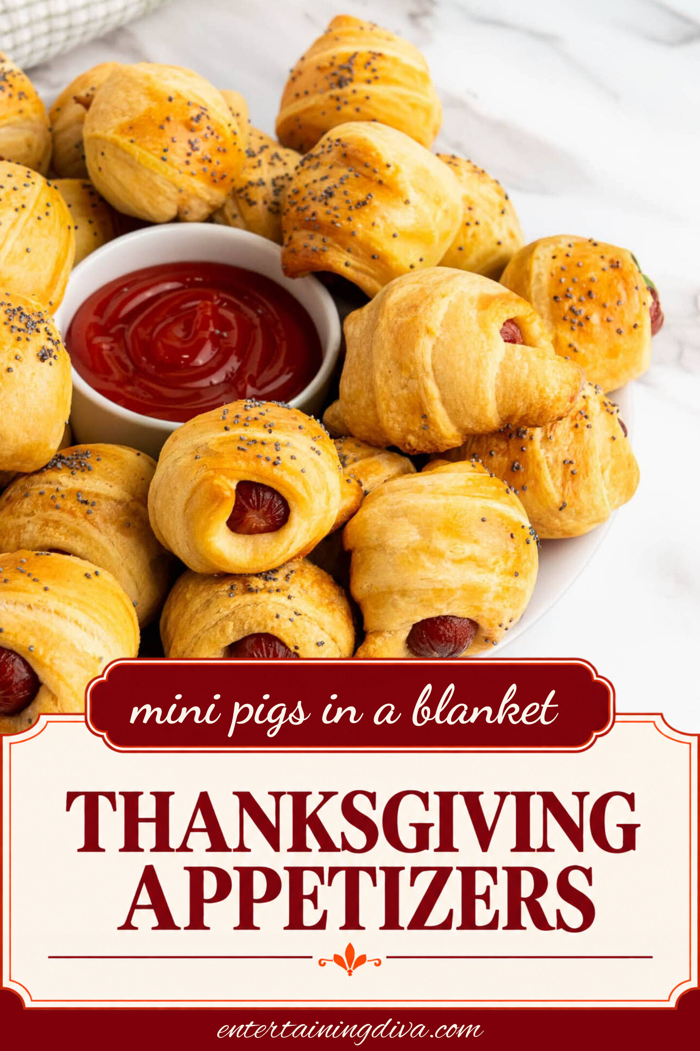 close up of pigs in a blanket on a plate with a bowl of ketchup in the middle