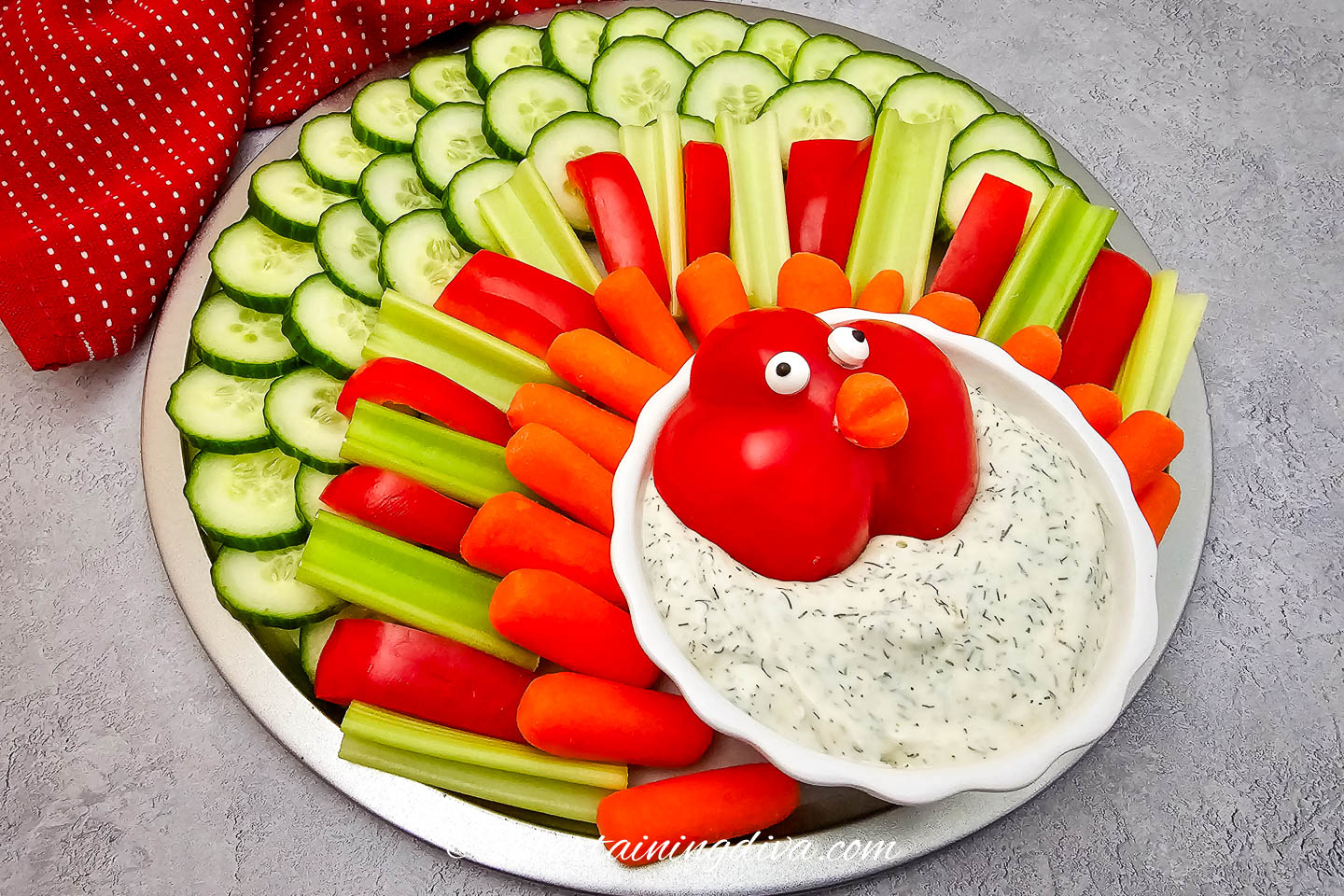 A turkey veggie tray on a countertop with a red napkin behind it