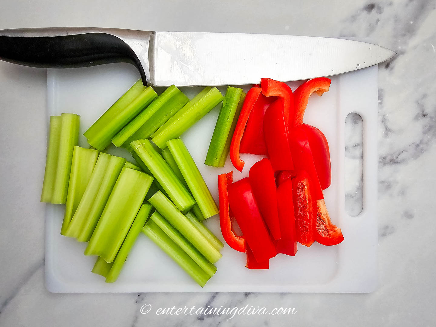 celery and red pepper slices on a cutting board